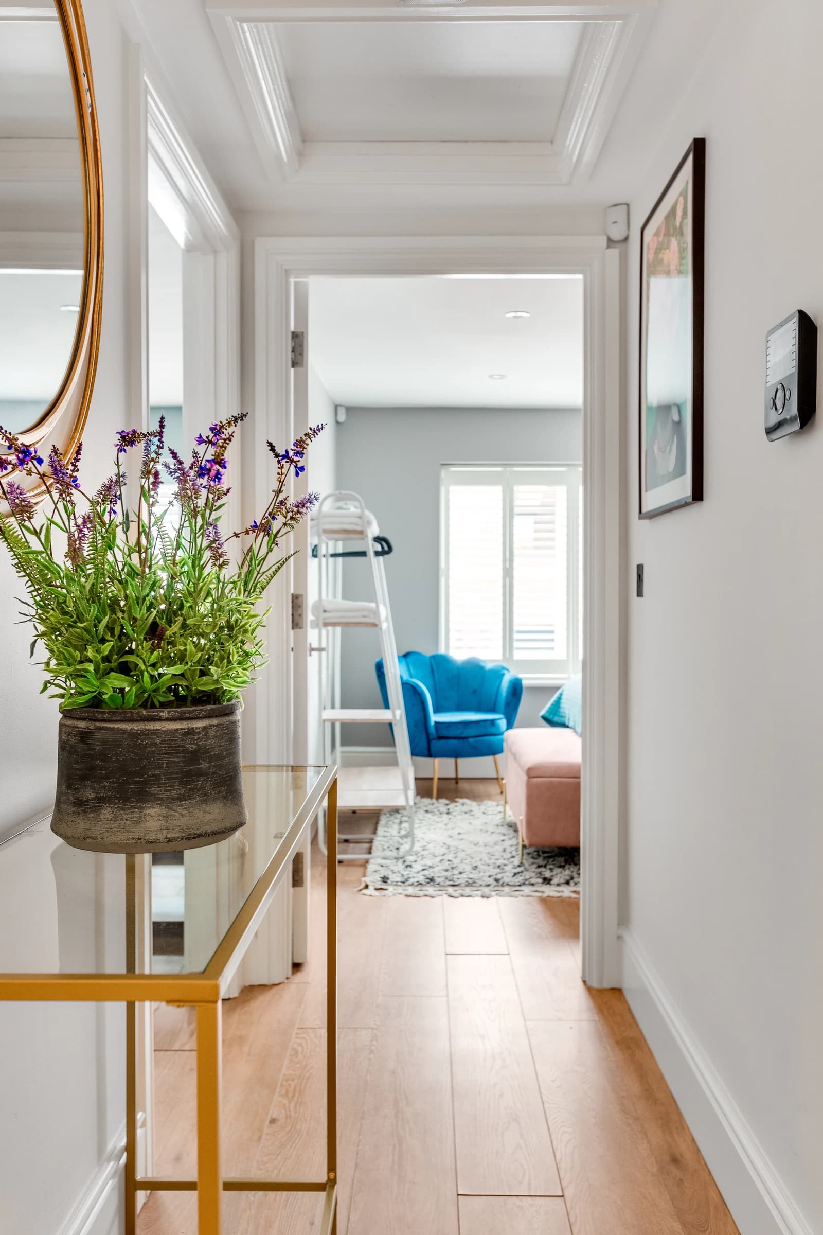 Blue chair, ladder shelf and fresh flowers at Station Road Flat 52a, Egham