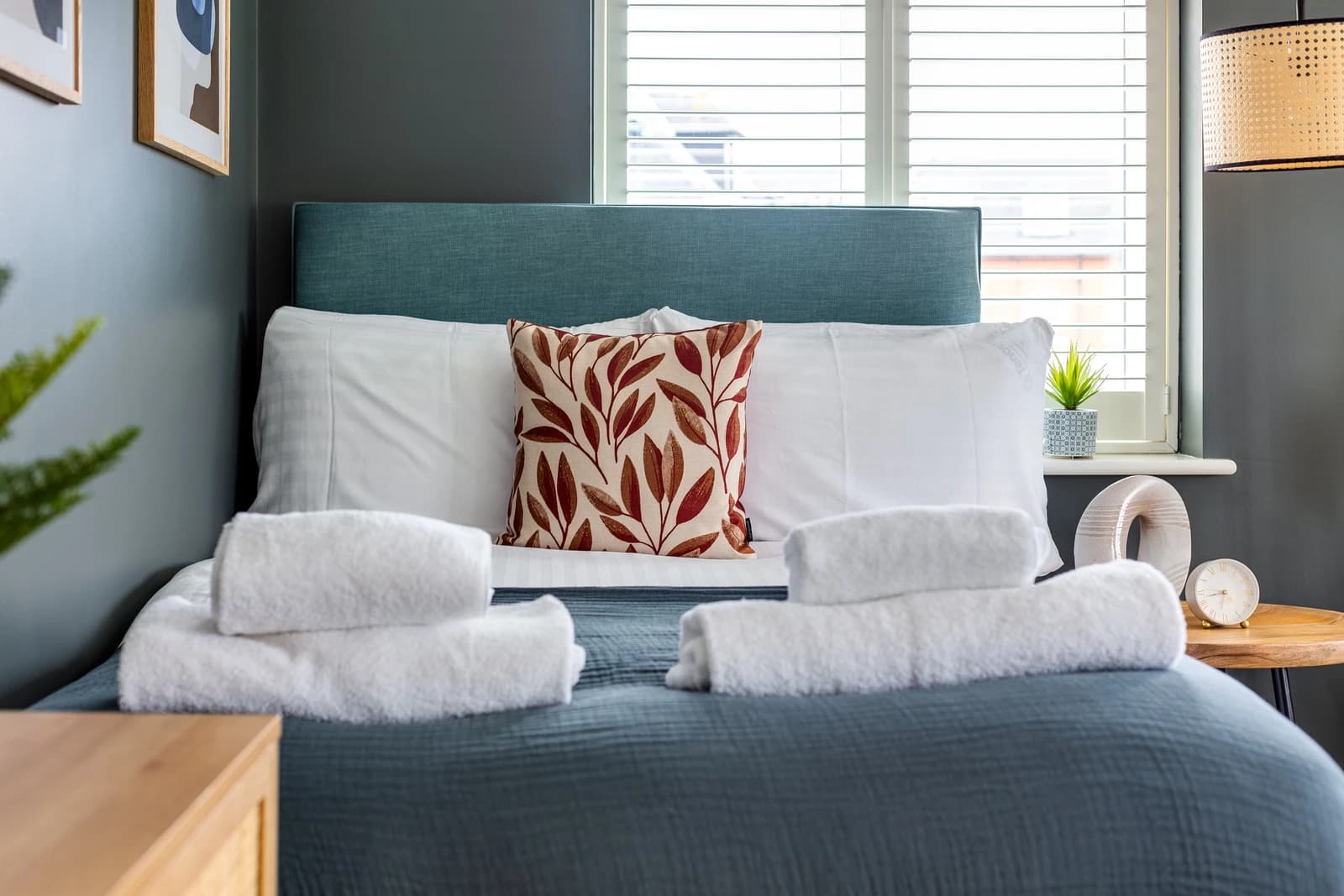Sofa bed with cushions and rolled towels in the living area at Boon House serviced apartment