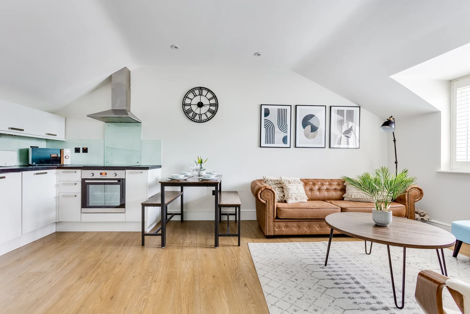 Open-plan living, dining and kitchen area with blue wall at Boon House apartment, Egham