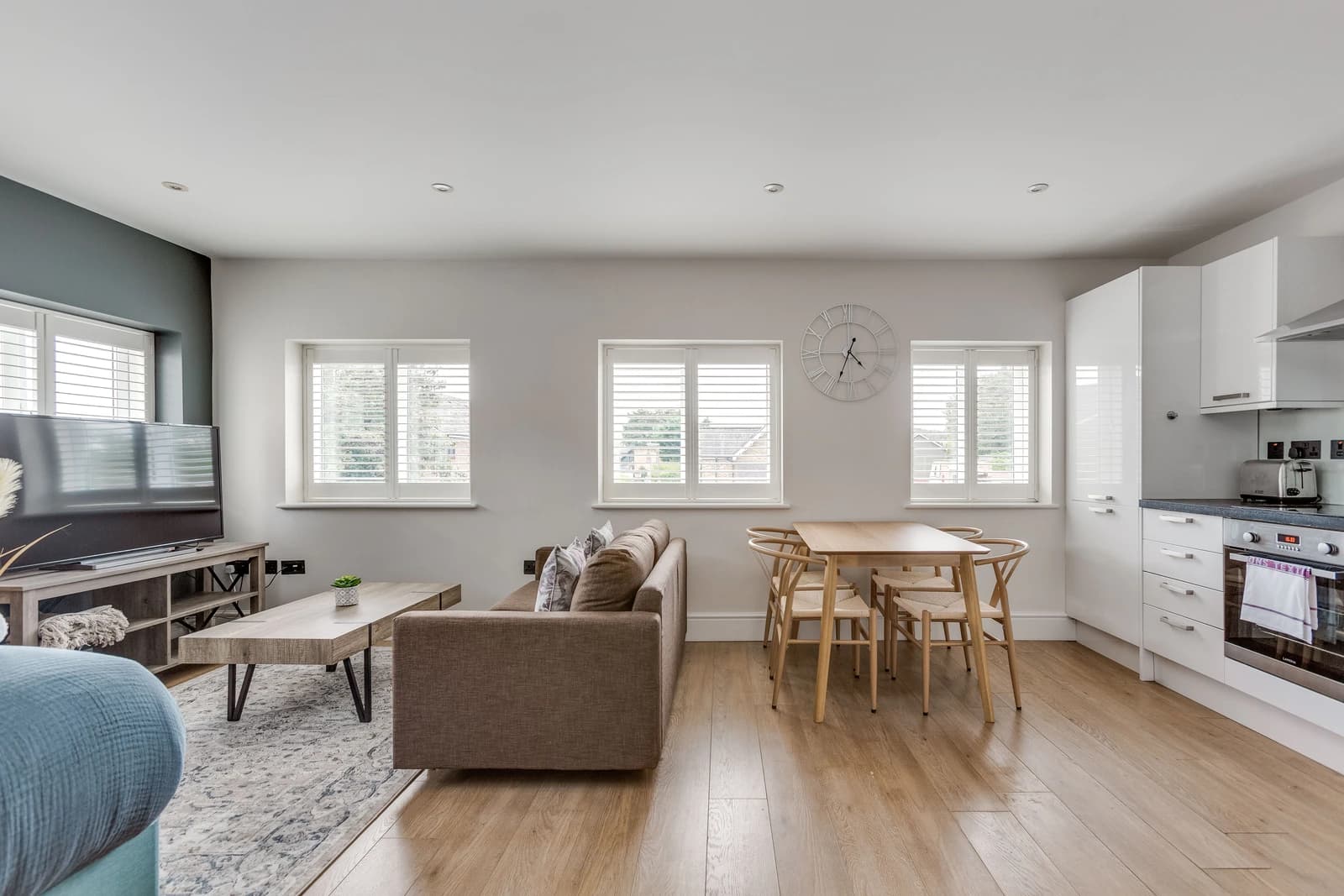 Open-plan kitchen, dining and living area with natural light at Boon House Flat 2, Egham