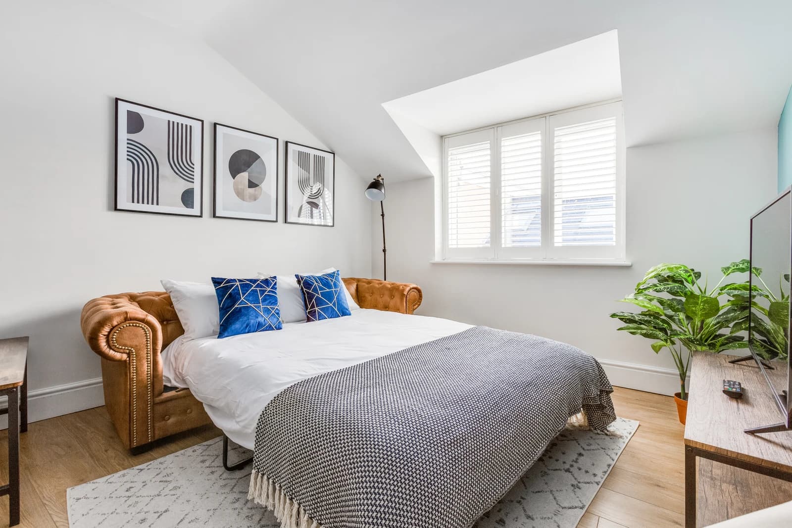 Sofa-bed with blue cushions at Boon House serviced apartment